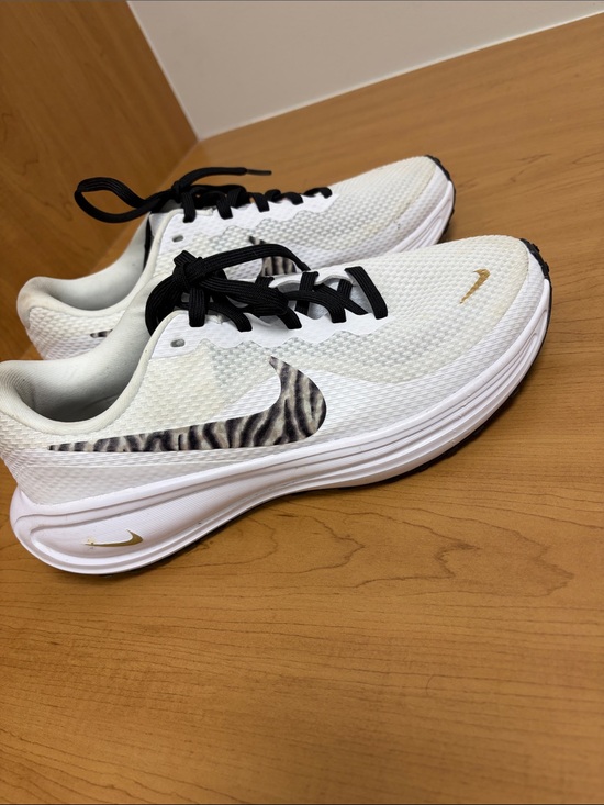 Nike Shoes - Nike White Women's Running Shoes with Zebra Swoosh and Gold Accents